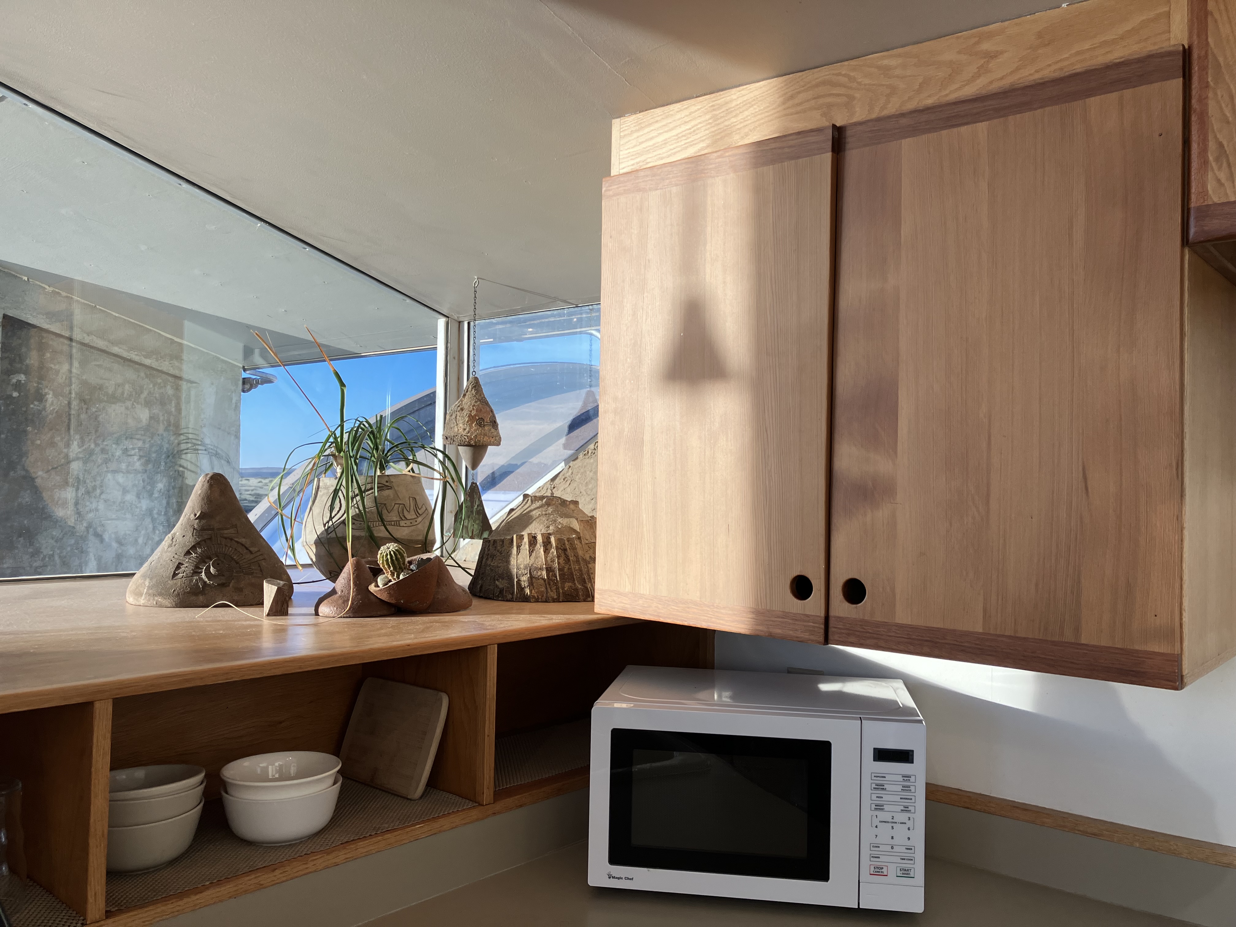 ‘zoomed out, showing cabinet doors in the kitchen’